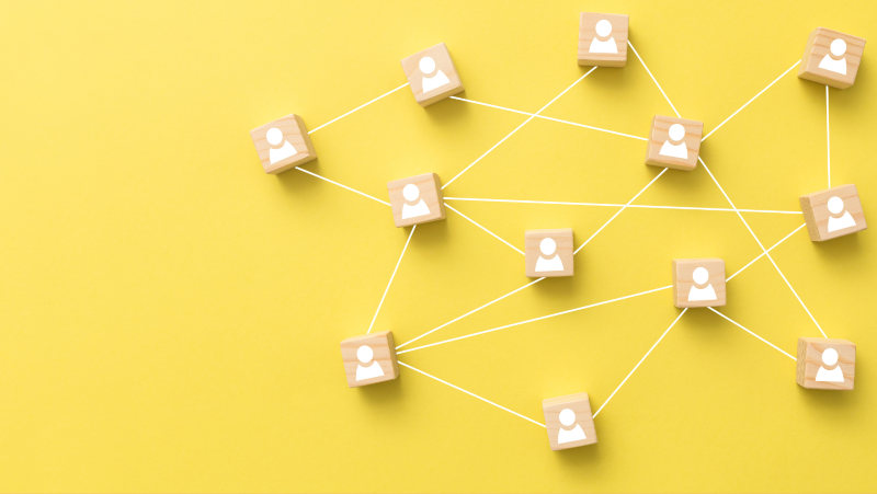 yellow background with people blocks joined together by string